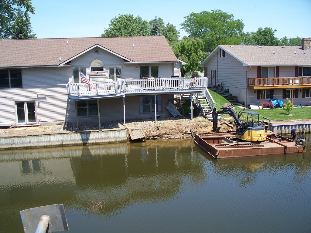 tearing down old wooden seawall_Grand River_Michigan